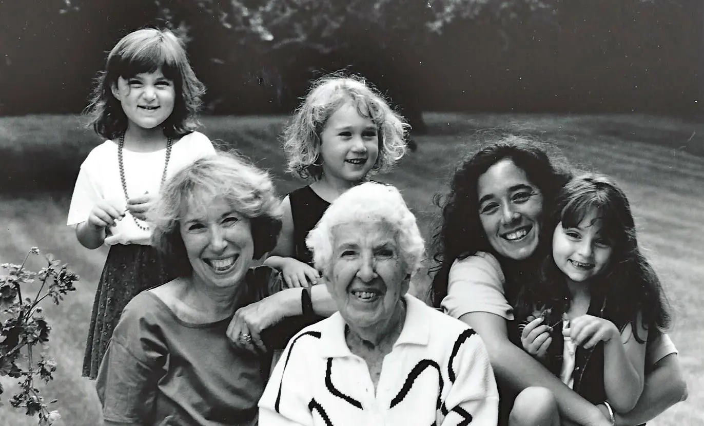 Smiling family group portrait in black and white.