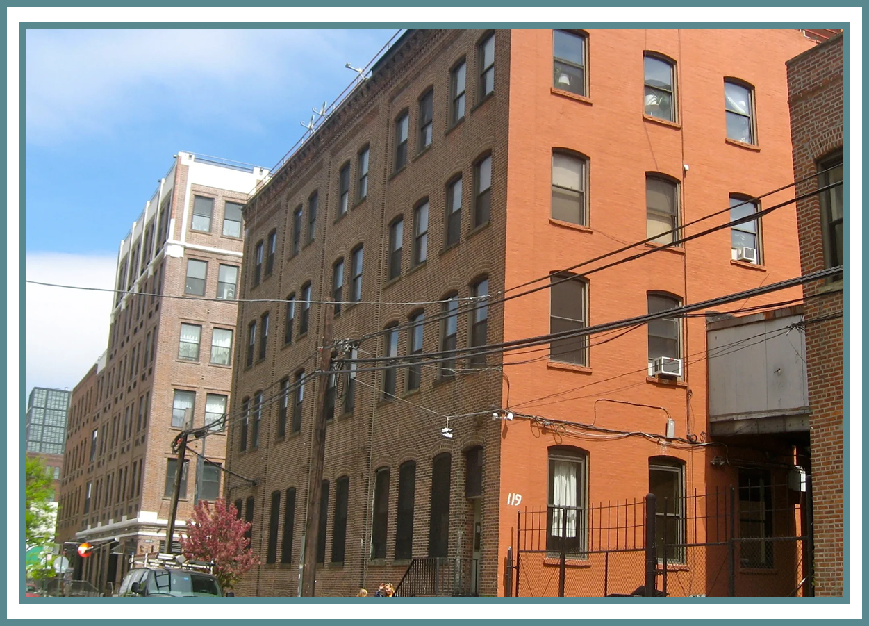 Brick apartment buildings on a city street.