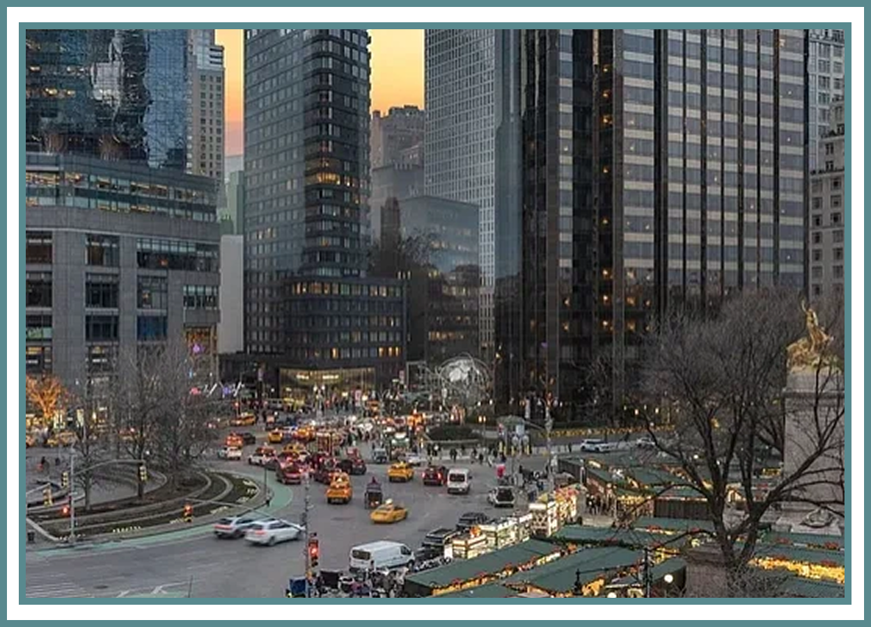 Busy city intersection with skyscrapers and traffic.