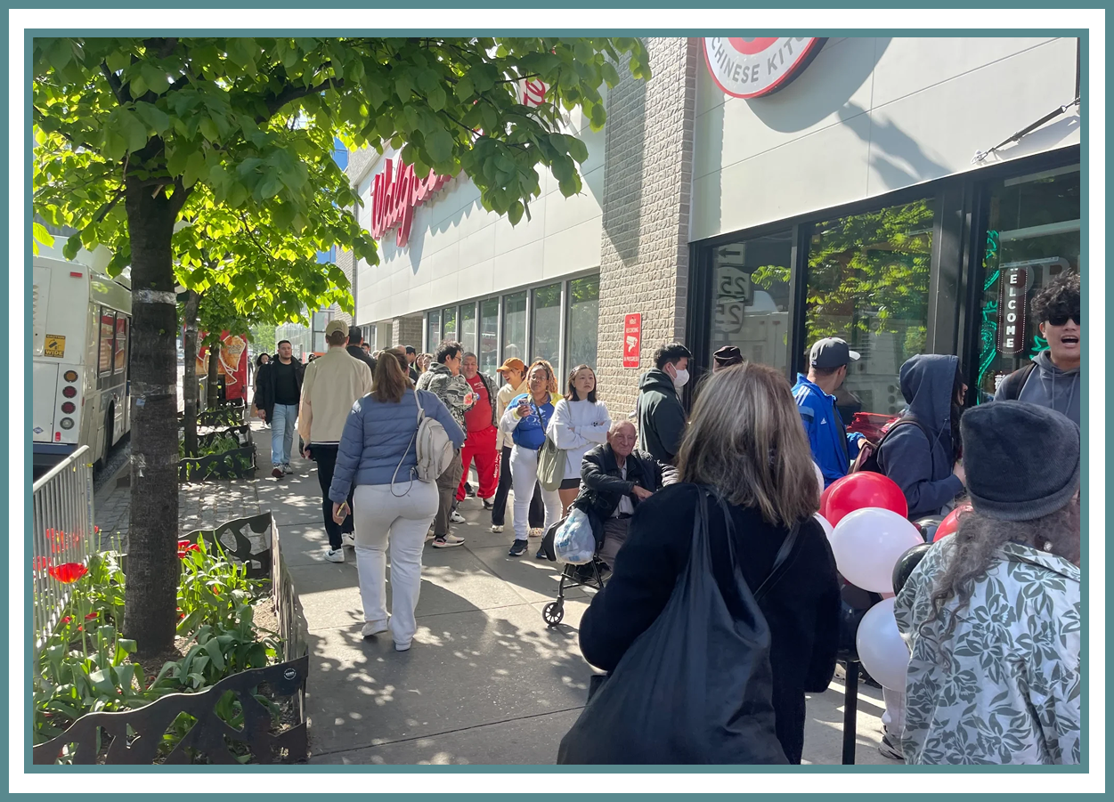 People in line outside a store entrance.
